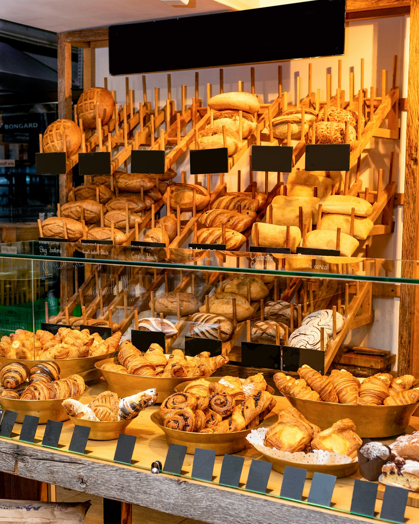 Bakery display case filled with fresh bread and pastries