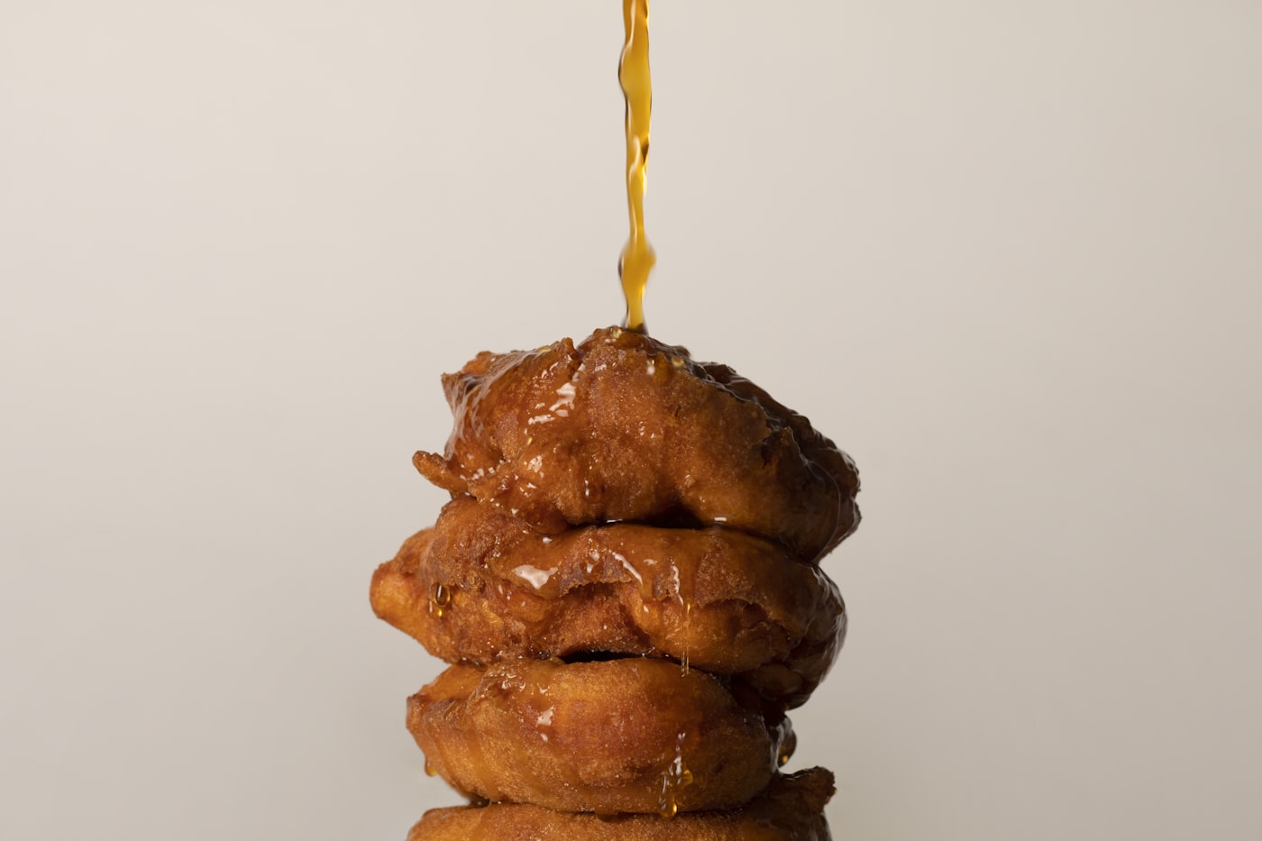 Stack of glazed old-fashioned apple fritters
